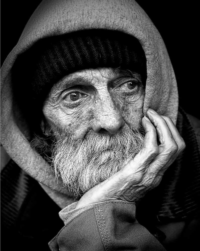 A homeless eldery man receiving counselling